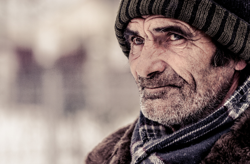 A man dressed warmly in a scarf and hat.