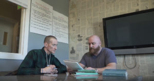 Robert sitting with a staff member
